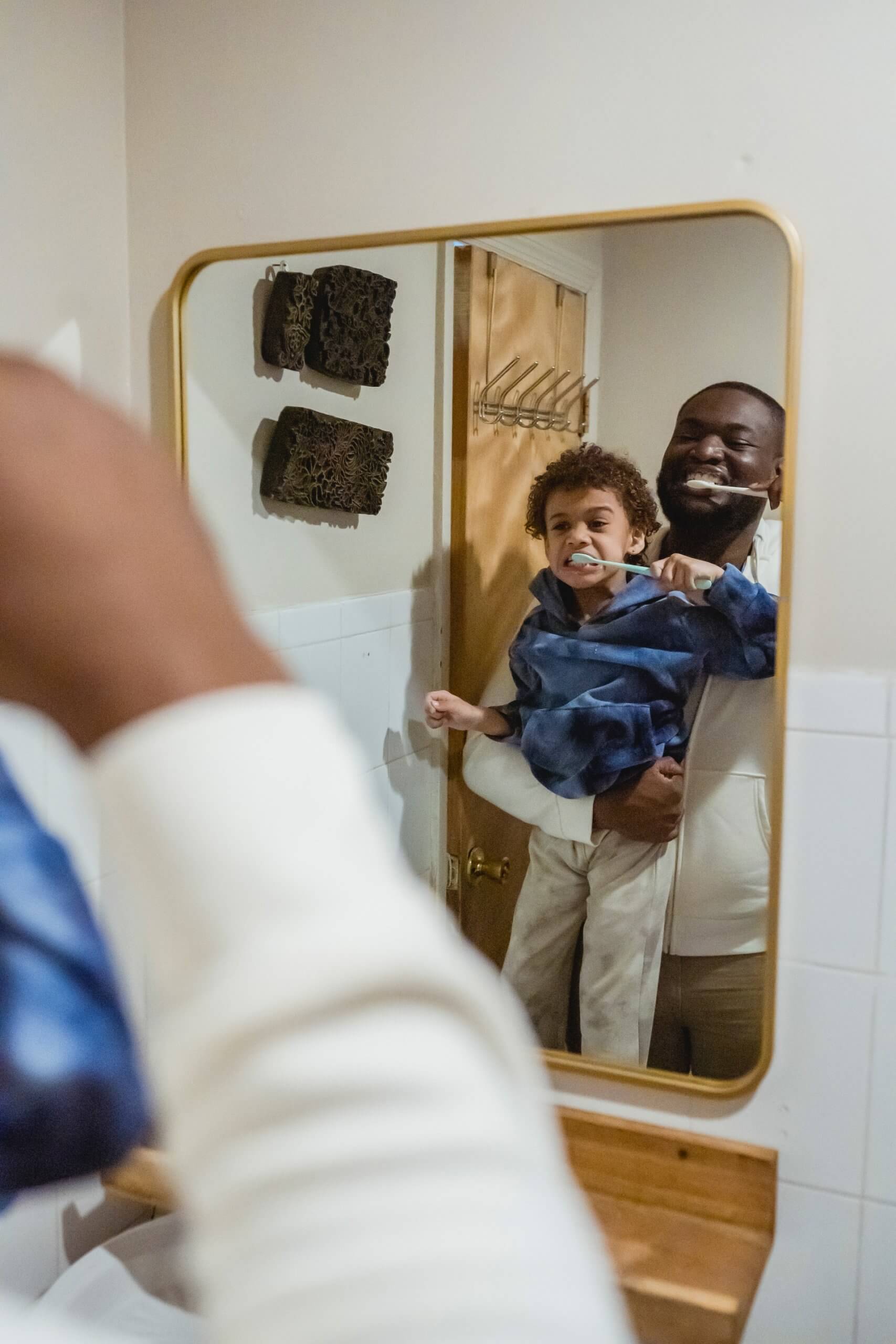 father and son brushing teeth together